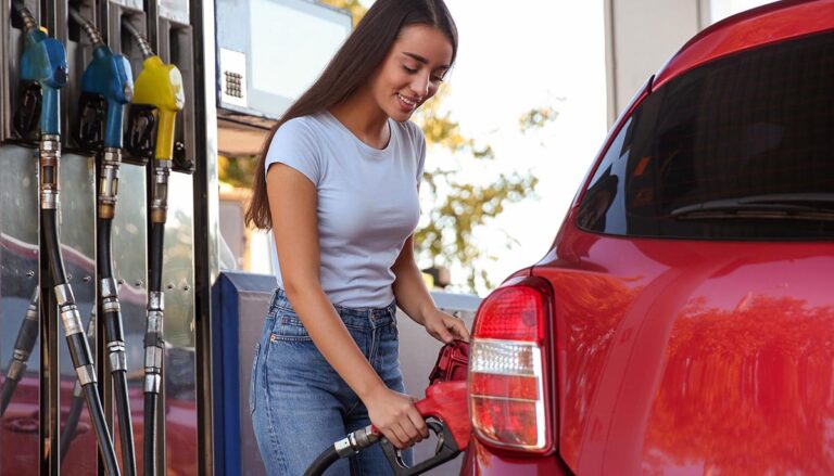 young woman fueling her car at a gas station