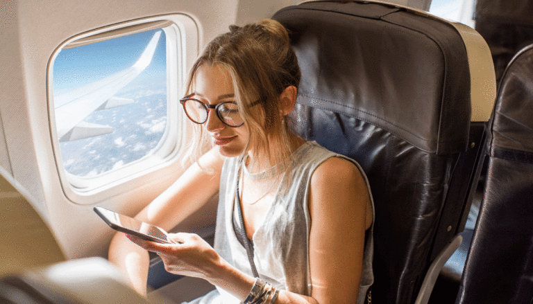 woman-looking-at-phone-on-airplane