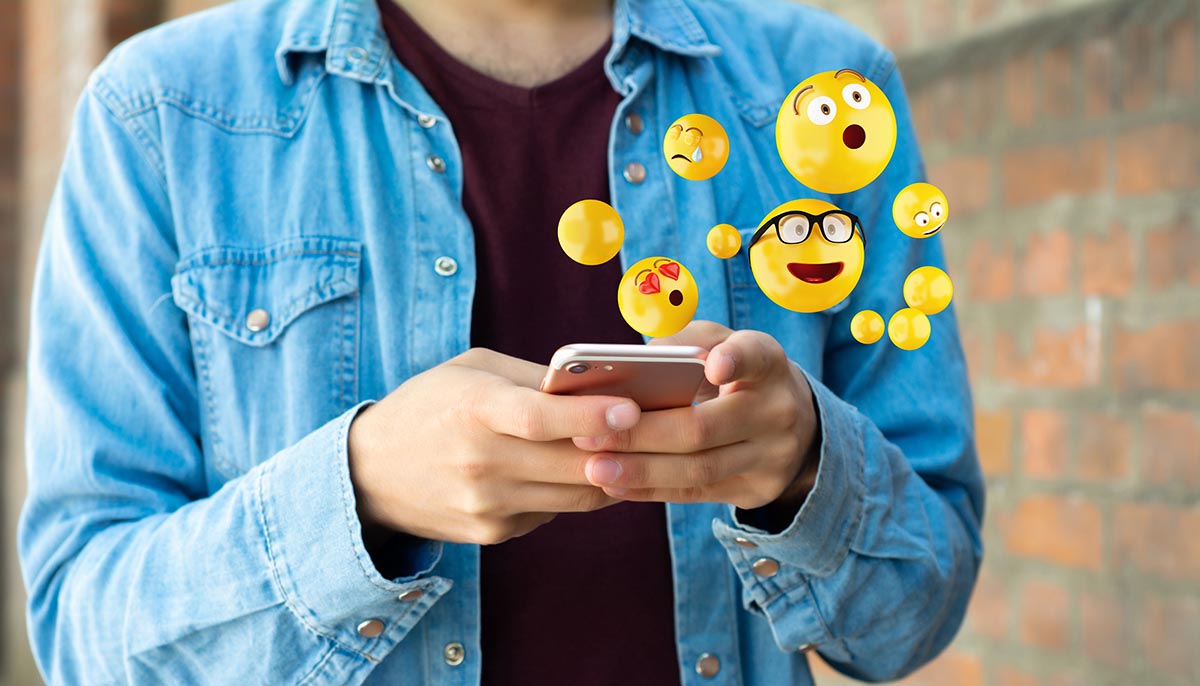 emojis floating away from smartphone