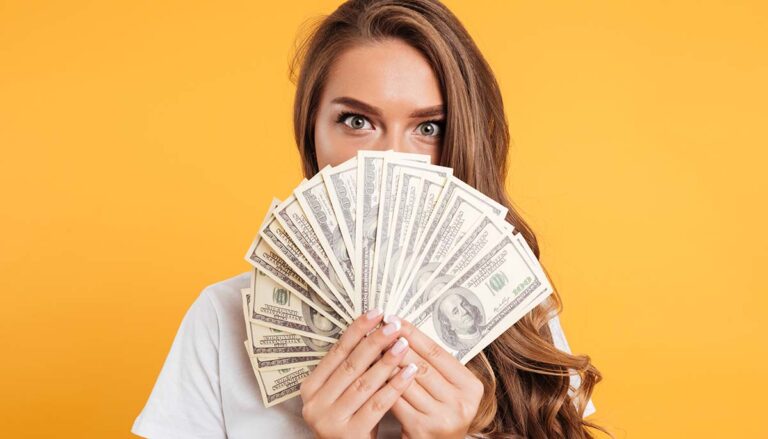 woman holding a fan of cash