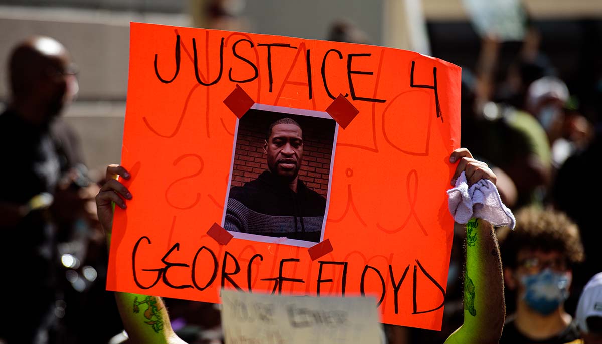 Miami Downtown, FL, USA - MAY 31, 2020: George Floyd death: people are protesting and rioting. Justice for George Floyd poster. People took to the streets against cruelty