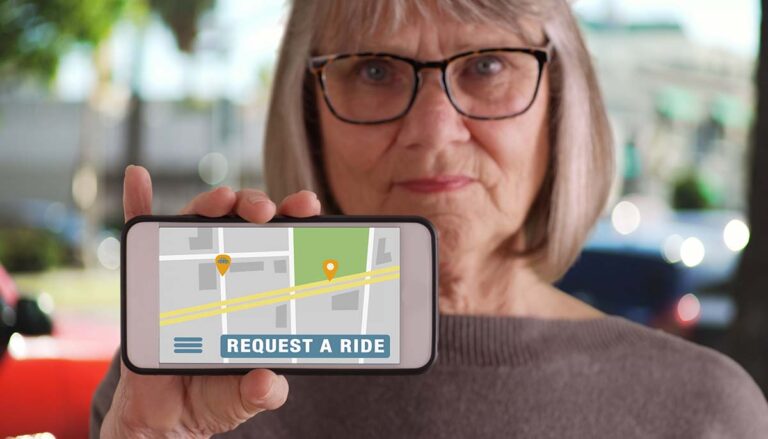 woman holds up a phone with a rideshare app