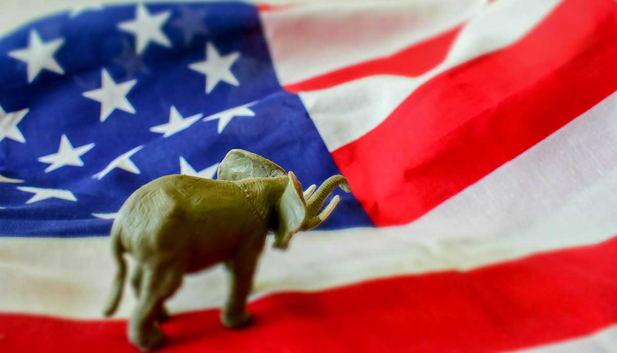 Republican elephant concept standing atop American flag