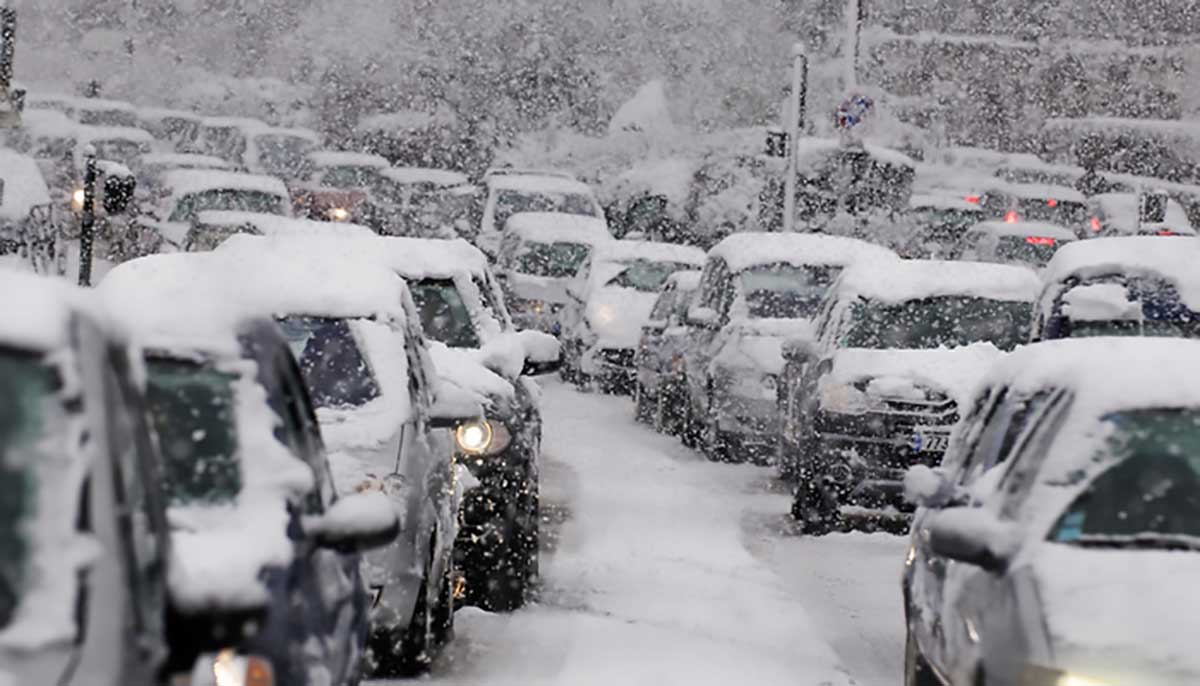 snowstorm buffets a traffic jam as drivers attempt to avoid heavy snowfall